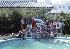 TVTV, a group shot at the pool in collective house, 1972. L to R: Curtis Schreier, Michael Couzens, Jody Siebert, Mickey Shamberg, Megan Williams, Allen Rucker, Anda Korsts, Tom Weinberg. Steve Christiansen, Wendy Appel, T.L. Morey, Hudson Marquez, Maureen Orth, Martha Coolidge, Skip Blumberg, Chip Lord, Nancy Cain (on raft.) Photo by Doug Michels.